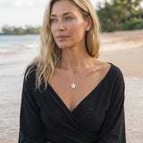 18mm 14k Plumeria Pendant with 0.05 carat diamond — worn on model (blonde, view 1)