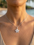 14k 15mm White Gold Plumeria Pendant — close-up on model