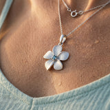 14k 15mm Plumeria Pendant with Blue Diamond — worn on model (blonde, view 4)