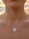 13mm 14k Plumeria Pendant with 0.03 carat diamond — close-up on model