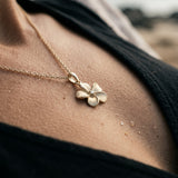 11mm 14k Plumeria Pendant with 0.02 carats diamond — worn on model (brunette, view 4)