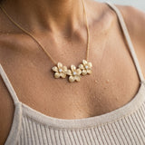 14k Plumeria Lei Slide Pendant with 3 diamonds — worn on model (brunette, view 4)