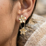 15mm 14k Plumeria Earring with 2 diamonds — worn on model (brunette, view 4)
