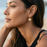 14k 13mm Plumeria Earrings with 2 Diamonds — worn on model (brunette, view 3)