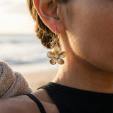 14k 13mm Plumeria Earrings with 2 Diamonds — worn on model (brunette, view 4)