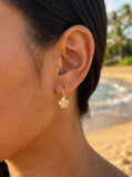 8mm 14k Plumeria Earrings with 2 diamonds — close-up on model
