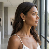 8mm 14k Plumeria Earrings with 2 diamonds — worn on model (brunette, view 1)
