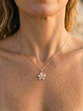 14k 15mm Plumeria Pendant with 0.04 Carat Diamond — close-up on model