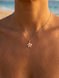 14k 13mm Plumeria Pendant with 0.03 carats diamond — close-up on model