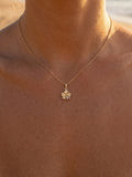 14k Hibiscus Pendant with .03ct Ruby and 01ct Diamond — close-up on model
