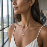14k Hibiscus Pendant with .03ct Ruby and 01ct Diamond — worn on model (brunette, view 1)