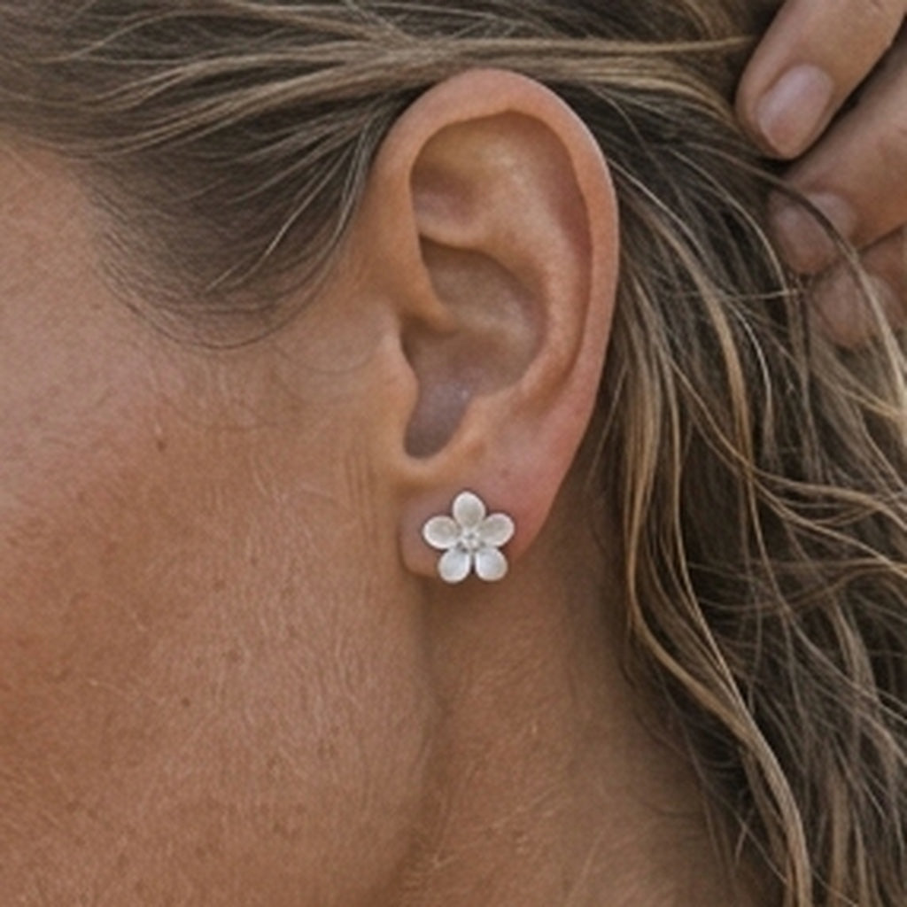Precious Silver 13mm Plumeria Earrings with 2 White Sapphire — worn on model (blonde, view 3)