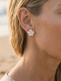 Precious Silver 11mm Plumeria Earrings with 2 White Sapphire — close-up on model