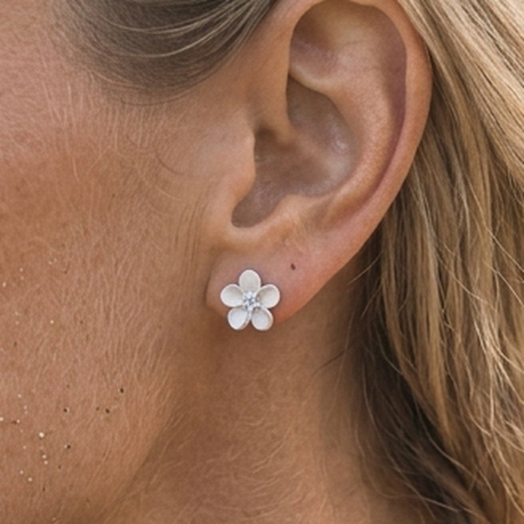 Precious Silver 8mm Plumeria Earrings with 2 White Sapphires — worn on model (blonde, view 3)