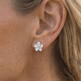 Precious Silver 8mm Plumeria Earrings with 2 White Sapphires — worn on model (blonde, view 3)