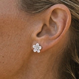 Precious Silver 8mm Plumeria Earrings with 2 White Sapphires — worn on model (blonde, view 4)