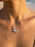 14k 22mm Crab Pendant with 2 Diamonds and 1 Tanzanite — close-up on model