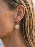 14k 15mm Sand Dollar Earring with 10 Diamonds — close-up on model