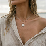 14k 21mm Sand Dollar Pendant with 12 diamonds — worn on model (brunette, view 4)