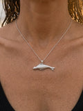 14k 40mm Seal Pendant "Searching" with 2 Diamonds — close-up on model