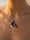 14k 40mm 2/tone (Black and White) Killing Whale Pendant with 2 Diamonds — close-up on model