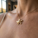 14k 20mm Sea Turtle Pendant with 2 Diamonds — worn on model (blonde, view 2)