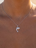 14k 15mm "Jumping Single" Dolphin Pendant with 0.01 carat blue diamond — close-up on model
