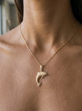 14k 28mm "Jumping Single" Dolphin Pendant with 2 diamonds — close-up on model