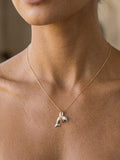 14k 2/tone 20mm "Jumping Loop" Dolphin Pendant with blue diamond — close-up on model