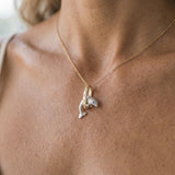 14k 15mm "Jumping Loop" Dolphin Pendant with 3 diamonds — worn on model (blonde, view 2)
