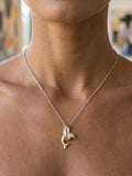 14k 15mm "Jumping Loop" Dolphin Pendant with 0.01 carat diamond — close-up on model