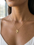 14k 15mm "Jumping Couple" Dolphin Pendant with 2 diamonds — close-up on model