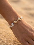 14k 15mm "Jumping Single" Dolphin Bracelet with 10 diamonds — close-up on model