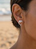 14k 15mm "Jumping Single" Stud Dolphin Earrings with 2 Diamonds — close-up on model