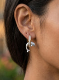 14k 15mm "Jumping Loop" Dolphin Earrings with 18 diamonds — close-up on model