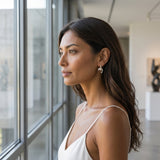 14k 15mm "Jumping Loop" Dolphin Earrings with 18 diamonds — worn on model (brunette, view 1)