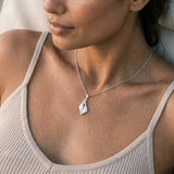 Precious Silver 20mm Seal Pendant "Dancing Couple" with 4 Diamonds — worn on model (brunette, view 3)