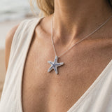 Precious Silver 22mm Starfish Pendant with 31 Blue Sapphires — worn on model (blonde, view 4)
