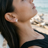 Precious Silver 10mm "Jumping Single" Dolphin Earrings with 2 Diamonds — worn on model (brunette, view 3)