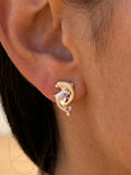 14k 15mm "Jumping Loop" Dolphin Earrings with 2 Blue Diamonds — close-up on model