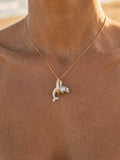 14k 15mm "Jumping Loop" Dolphin Pendant with 0.01 Blue Diamond — close-up on model