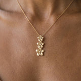 14kw 6, 8 & 10mm Plumeria Lei Slide Pendant with 3 diamonds — worn on model (brunette, view 2)