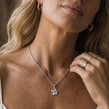 8mm 14k Plumeria Pendant with 0.02 carats blue diamond — worn on model (blonde, view 1)