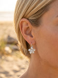 14k 11mm Plumeria Earrings with Diamonds — close-up on model